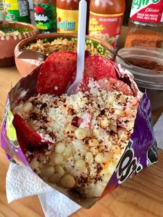 a bowl filled with food on top of a wooden table