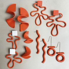 an assortment of orange and white objects on a gray surface, including wire cutters