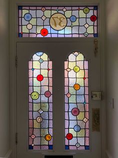 a white door with two stained glass windows on it's sides and the number 37