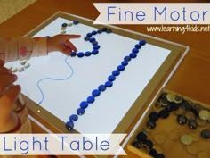 a child is making a light table with beads