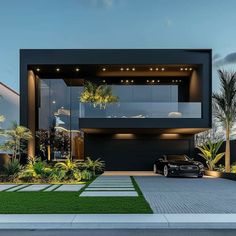 a black car is parked in front of a modern house with grass and palm trees