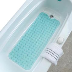 a blue bath mat sitting on top of a white bath tub