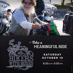 a man with a long white beard riding a motorcycle in front of a sign that says bikers with boxes