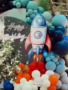 a rocket ship birthday party with balloons and streamers