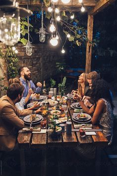 a group of people sitting around a table eating food