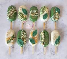 there are many green and white desserts on sticks