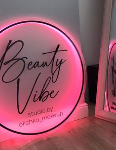 a neon sign that says beauty vibe on it