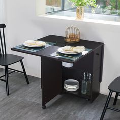 a kitchen table with two chairs next to it