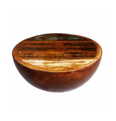 a wooden bowl sitting on top of a white surface with green and brown stripes in it