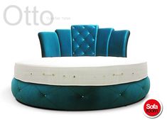 an oval bed with blue velvet upholstered headboard and buttoned buttons on the back