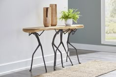 a wooden table with two vases on it and a rug in front of it