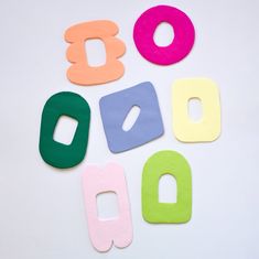 colorful wooden letters laid out in the shape of an oo, q, b, and d