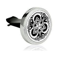 a black and white photo of an ornate design on a round metal object with silver accents