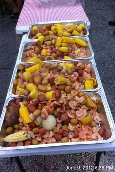 several trays filled with food sitting on top of a table