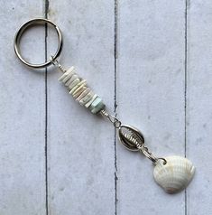 a keychain with a seashell hanging from it