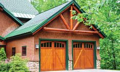 a two car garage with green trim on the roof