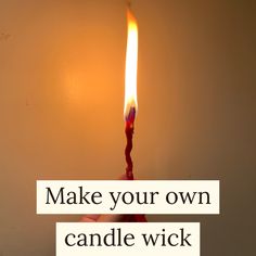 a candle that is burning with the words make your own candle wick on it