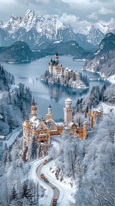 an aerial view of a castle surrounded by snow covered mountains and lake in the foreground