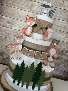 a three tiered cake decorated with woodland animals