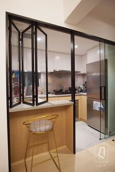 an open kitchen and dining area with glass walls