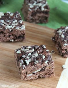 four pieces of chocolate brownie on a wooden cutting board