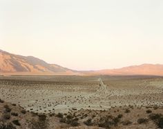 an open desert with mountains in the background