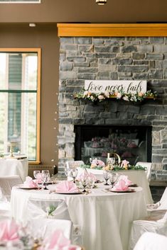 the tables are set up in front of the fireplace for an elegant wedding breakfast or reception