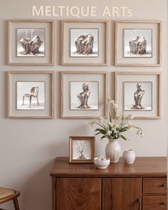 a wooden cabinet sitting next to a wall with pictures on it