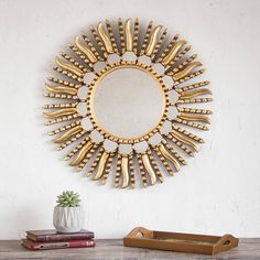 a mirror sitting on top of a wooden table