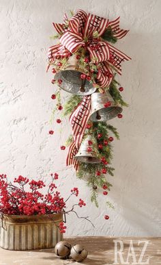 bells are hung on the wall with red and white ribbons