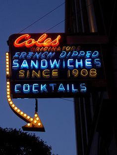 the neon sign for cole's restaurant in san francisco, california is lit up at night