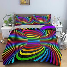 a bed with a colorful comforter and pillows