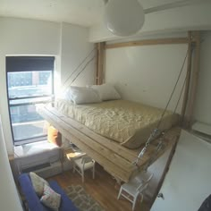 a bed suspended from the ceiling in a room