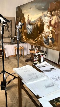 an artist's studio with paintings on the wall and a microphone in front of it