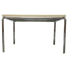 a white table with metal legs and a wooden top on it's side, against a white background