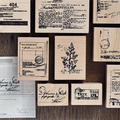 some rubber stamps are laying on top of a wooden table with other stamping items