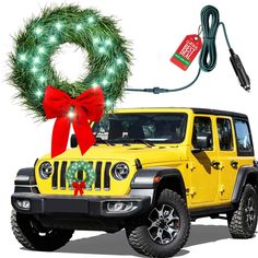 a yellow jeep with a wreath on top and a red ribbon around it's front