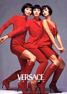 three women in red dresses and high heeled boots are posing for the camera with their arms around each other