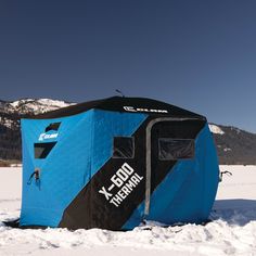 a blue and black tent sitting in the snow