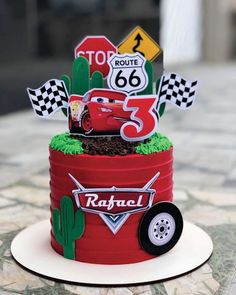 a birthday cake made to look like the cars from disney pixars is on display