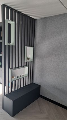 an empty room with black and white stripes on the wall, some shelves are open