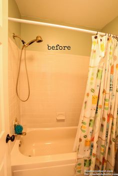 a bath tub sitting next to a shower curtain