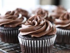 cupcakes with chocolate frosting sitting on a cooling rack