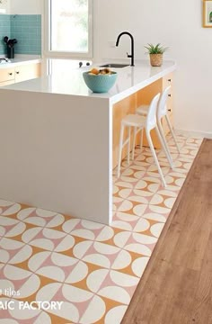 a kitchen with an orange and white tile floor, counter top and island in the middle