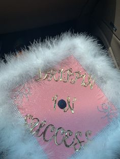 a pink and white graduation cap with the words happy to be success written on it