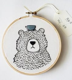 a bear with a cup on its head is shown in the hoop, next to a price tag