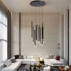 a modern living room with white couches and chandelier hanging from the ceiling