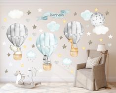 a child's room with hot air balloons and stars on the wall