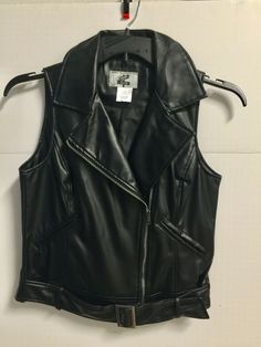 REV UP YOUR STYLE IN THIS WOMEN'S "COOL" FAUX LEATHER MOTO VEST BY "BROOME & ALLEN"...SIZE SMALL (PLEASE CHECK MEASUREMENT FOR CORRECT SIZE)...NEW W/O TAGS...BLACK FAUX LEATHER POLYURETHANE...BLACK POLYESTER SATIN LINING...BUST MEASURES 19" FLAT ACROSS PIT TO PIT...18" WAIST...21" BACK LENGTH... ***LIVE ON THE WILD SIDE, AND GO FOR IT!!... <> KEEP CHECKING MY AUCTION FOR MORE "MOST WANTED" APPAREL FROM MY ZANY WOMEN'S VEST COLLECTION...THANKS FOR LOOKING...HAPPY BIDDING!...YOUR BUSINESS IS GREAT Biker Vest With Zipper Closure For Fall, Spring Biker Vest In Black, Spring Black Biker Vest, Fitted Fall Vest With Zipper Closure, Fitted Vest With Zipper Closure For Fall, Fitted Biker Vest With Zipper Closure, Sleeveless Fitted Leather Biker Jacket, Fitted Sleeveless Leather Biker Jacket, Fitted Sleeveless Biker Jacket For Biker Events