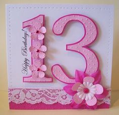 a pink and white birthday card with flowers on the number 13, decorated with lace